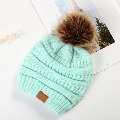 China JOINT Hot Sale Adult Knitted Pom Pom Beanie Hat Custom Winter Hats for sale