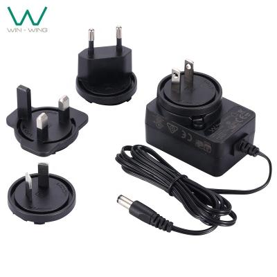 China PC and ABS compact design 5V 5.5V 6V 2A 2000mA wall mount power adapter with interchangeable plugs for sale