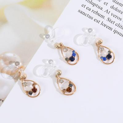 China 2022 Popular Hollow Brass Personality Earrings Fashion Designer Rhinestone Resin Elegant Non-punch Earrings for sale