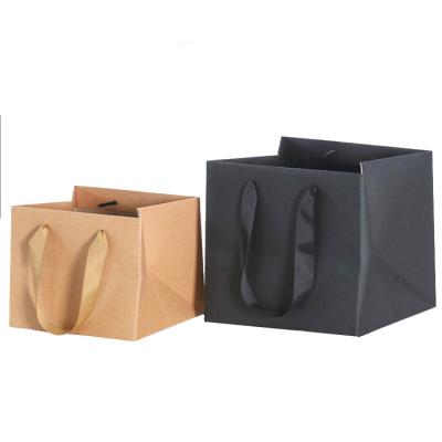 China Recyclable High Quality Flower Packing New Year Paper Bag With Ribbon Handle Kraft Paper Bag for sale