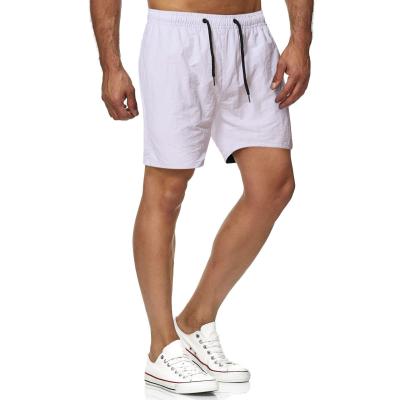 China Polyester/Cotton Solid Color Shorts European And American Men'S Casual Handsome Sea Summer Surf Pants Drawstring Shorts for sale