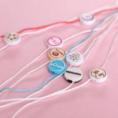 China Other Custom Own Brand Embossed Logo Label Clothing String Hang Tags Plastic Hang Labels Seal With Nylon String for sale