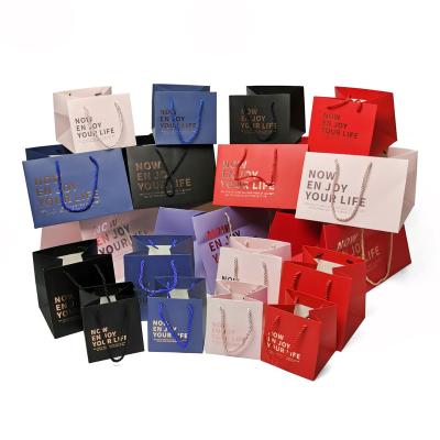 China Recycled Materials Hot Gold Foil Staming Printed Logo Kraft Paper Gift Bags Customized Custom Luxury Packaging Waist Ribbon Handle Boutique Shopping for sale