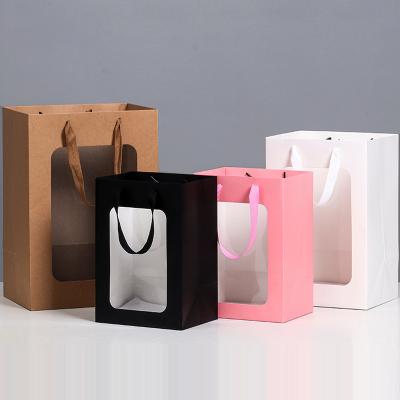 China Recycled Materials Hollow Out Window Hollow Flower Paper Gift Bag Custom Cheap Waterproof Nice Portable Foldable Wedding Flower Bag for sale