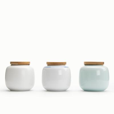 China Small Viable Decorative Ceramic Porcelain Tea Coffee Sugar Storage Jar Canister Set With Wooden Lid for sale