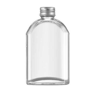 China Beverage Wholesale Luxury Oblique Shoulder Unique Reusable Glass Coffee Bottle With Lids for sale