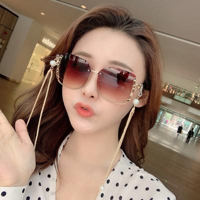 China Rimless in 2022, wholesale new big frame women's fashion rimless sunglasses with chain sunglasses for sale