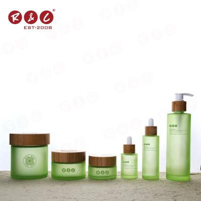 China Personal Buy China Matte Green Unique Color 50ml 3oz 5oz 180ml Skin Care Packaging Customize Embossing Borosilicate Glass Lotion Jars With Bamboo Lid Set for sale