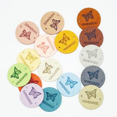 China Durable Round Leather Butterfly Handmade Labels Tags For Bags Clothes DIY Sewing Garment Accessories for sale