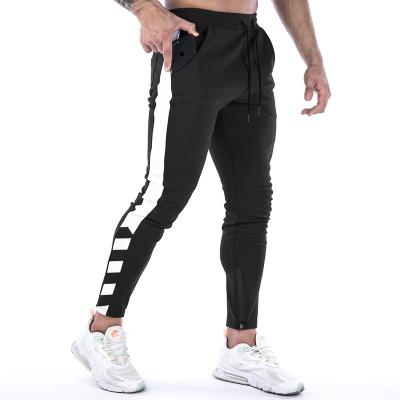 China Autumn Mid Waist Patchwork Side Stripe Splice Pocket Drawstring Design Pants 60% Cotton Breathable Slim Men's Casual Sweatpants for sale