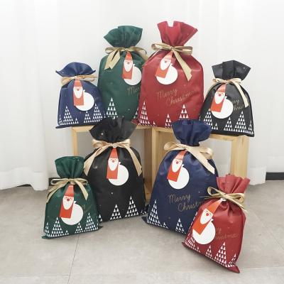 China Custom Gift Bag PP Drawstring Santa Gift Pouches Christmas Celebration Non Woven Rope Bag for sale