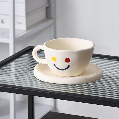 China New Arrived Viable Cute Handmade Irregular Creative Matte Ceramic Smile Coffee Cup And Saucer Tea Cup With Dish Home Office Tableware for sale