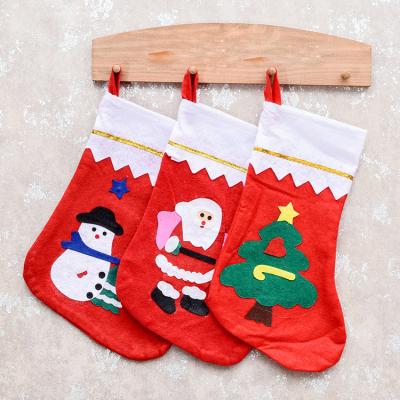 China Classic Christmas Decorations Santa Claus Nonwoven Fabric Can Hold Apple Gift Bag Christmas Socks for sale