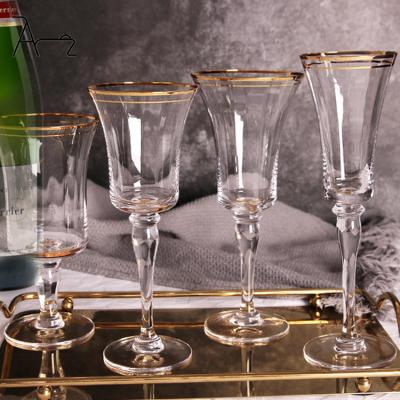 China Durable Wholesale Glassware Wedding Decor Glass Wine Goblets Unique Gold Trim Design Colored Clear Modern Champagne Glasses & Flutes for sale