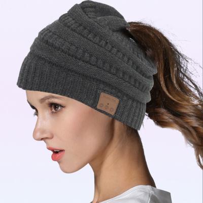 China COMMON Customized Warm Winter Music Acrylic Hat With Wireless Earphone Ponytail Knitted Beanie Hat For Women for sale