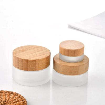 China New Design Personal Care Wooden Cap Frosted Serum Jar Glass Bamboo Cosmetic Packaging Bottle for sale