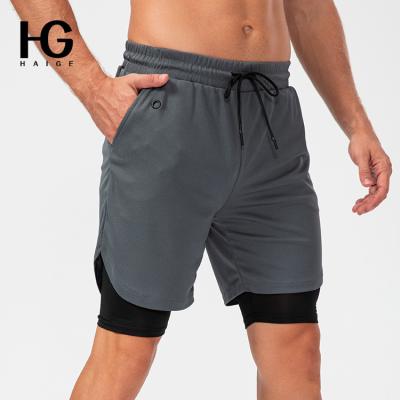 China 2022 New Breathable Men 2 in 1 Quick Dry Mesh Breathable Double Layer Shorts Sports 1 2 Piece Gym Shorts With Earphone Hole Running Shorts for sale