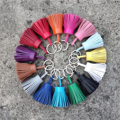 China New Trendy Color Small Straw Skirt Sheepskin Tassels Car Ring Handbags Candy Head Pendants for sale