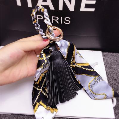 China Personalized Leather Hanging Fashion Tied Creative Fashionable Ring Chain PU Tassel Key Chain Silk Scarf Bag for sale