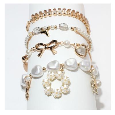 China FASHIONABLE factory custom baroque irregular chime bangles and bangles flush pearl butterfly knot tennis pendent chain bracelet for sale