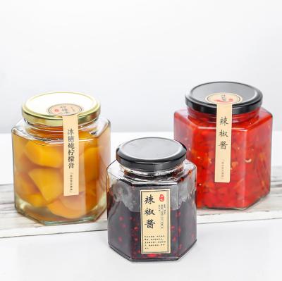 China Food Grade Stocked 45ml To 730ml Empty Clear Hexagonal Glass Jar With Multicolor Metal Lid for sale