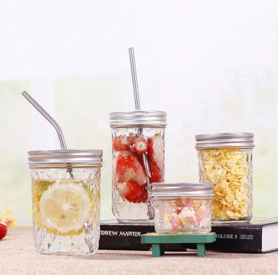 China Beverage Diamond Rhombus Embossed Glass Bottle Mason Jar Juice Drink Cup With Straw for sale