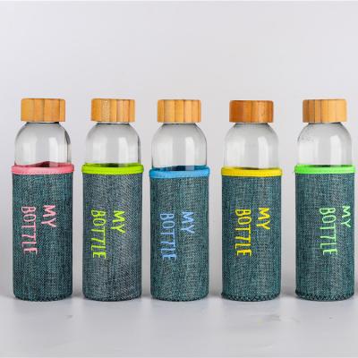 China Custom Logo Reusable Stocked 420ml 500ml Round Portable Glass Water Bottle With Bamboo Cover for sale