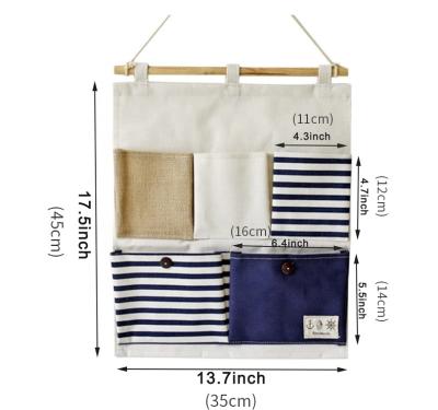 China Jinliu 5 Pockets Organizer Foldable Cotton Linen Storage Bag Wall Mounted High Quality Viable Hanging Pocket for sale