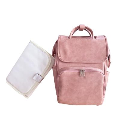 China Free Sample Multifunctional Pure Pink Color PU Leather Diaper Bags Backpack Maternity Changing Pad With Stroller Straps Baby Bag for sale