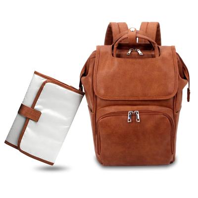 China Free Sample Multifunctional Pure Brown Color PU Leather Diapers Bags Backpack Changing Maternity Pad With Stroller Straps Baby Bag for sale