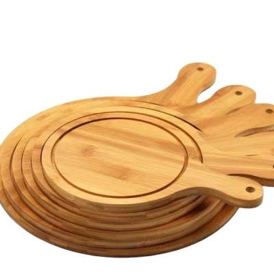 China Sustainable Natural Organic Bamboo Paddle Pizza Cutting Board Perforated Wooden Pizza Panels With Grooves for sale