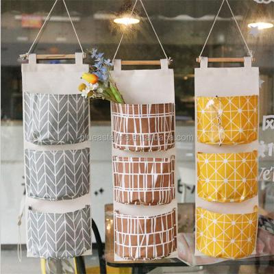 China Eco - Friendly Cotton Canvas Storage Bag Hanging Multi - Storey Cloth Door Debris Storage for sale