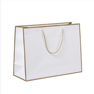 China Professional Recycled Materials Gold Silver Foil Stamping Logo Store Carrier Shopping Paper Bag for sale