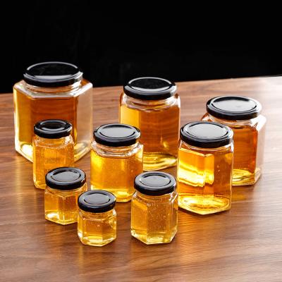 China Viable Hexagon Glass Aluminum Cover Honey Bottle Thickened Bottom Honey Bottle Leakproof Jam Bottle for sale