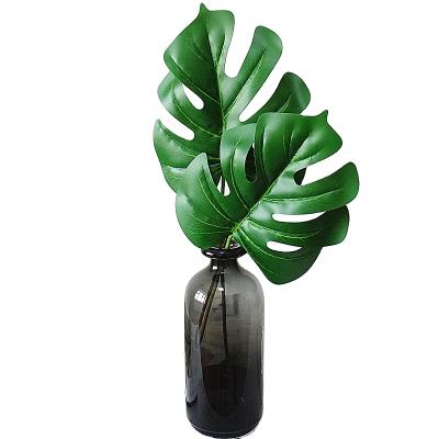 China Artificial simulation plastic monstera palm leaves are used to decorate the balcony decoration courtyard decoration living room for sale