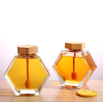 China Eco-friendly Recyclable Glass Food Grade Candy Storage Container 50ml 100ml 200ml 300ml Honey Jars Hexagonal Glass Bee Jar For Honey Wooden Lid for sale