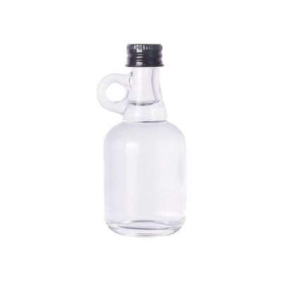 China Eco-friendly Recyclable Empty Round 50ml Liquor Spirits Wine Bottles Small Glass Bottles With Handle for sale