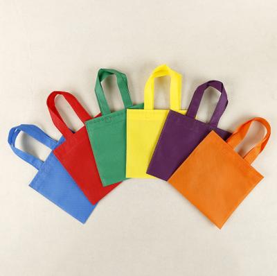 China Reusable Party Non-Woven Favor Bags 9.5×9.5 Inch Pinata Goodie Gift Bag Colorful Tote Candy Bags For Birthday Weeding Party for sale