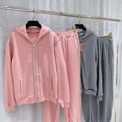 China Fashion zipper sweater and pant suit women winter sustainable clothing 2 pieces set sweatsuit rivets hoodie for sale