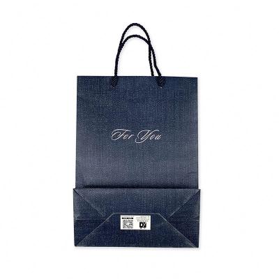 China Packing Box Logo Hot Foiled Stamping Black Matt Paper Bag With Handle Paper Shopping Bag for sale