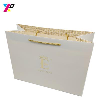 China Top quality recyclable custom gold logo hot stamping white shopping paper bag for wedding gift for sale