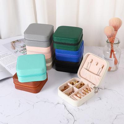 China Simple Modern Jewelry Travel Case with Mirror Organizer Display Boxes PU Leather Zipper Portable Earrings Necklace Ring Jewelry Storage Box for sale