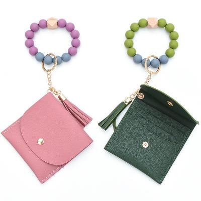 China Souvenir Gifts Promotion Women Coin Purse Change Wallet Coin Pocket Card Holder Clutch With Silicone Wristbands Key Chain Ring Tassel Zip for sale