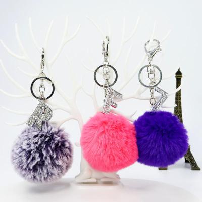 China Souvenir Gifts Promotion 2022 Hot Sale Rabbit Wool Ball With Diamond Alloy 26 Letters English Tassel Key Chain For Women for sale