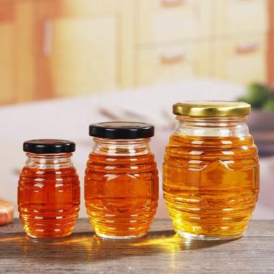 China Freshness Preservation Factory Price Wholesale Different Sizes Hive / Honeycomb Shaped Glass Honey Jar for sale