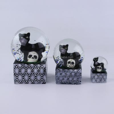 China Custom Europe 2018 Halloween Decor Snowball Skull Black Cat Concrete Base Snow Globe for sale