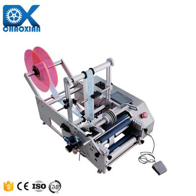 China Low Price Manual Opp Tapered Round Bottle Labeling Machine Machinery Pet Water Bottle Sticking Te koop