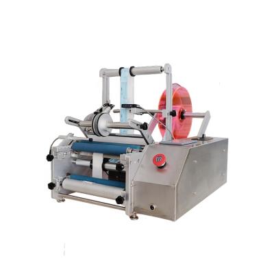 China Manual Food Medical Round Bottle Labeller Adhesive Sticker Labelling Machine Label Dispenser en venta