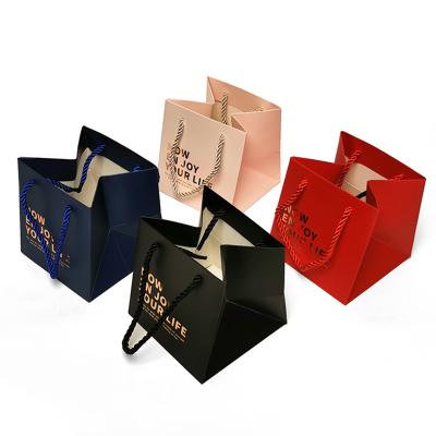 China Recycled Materials Jewelry Cosmetics Gift Bags Pink Apparel Gift Packaging Tote Paper Bags for sale