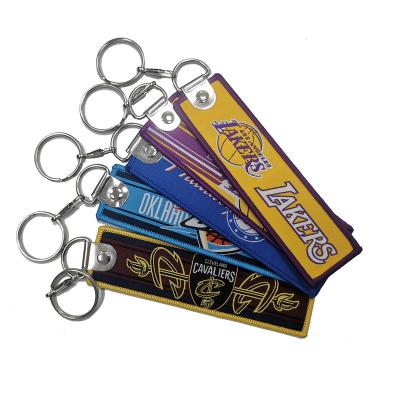 China Cheap Europe Promotional Gifts Jet Tag Fabric Embroidery Custom Keychains Basketball Teams Woven Key Chain for sale